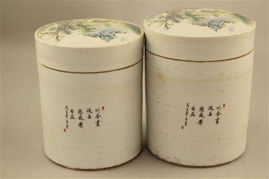 Two Chinese famille rose cylindrical jars and covers, 13cm and 13.5cm